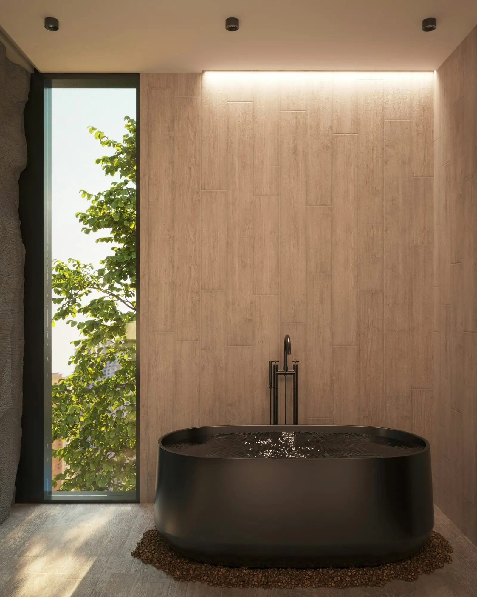 Matte black freestanding bathtub on a stone floor beside a tall window, with a floor-mounted tub filler