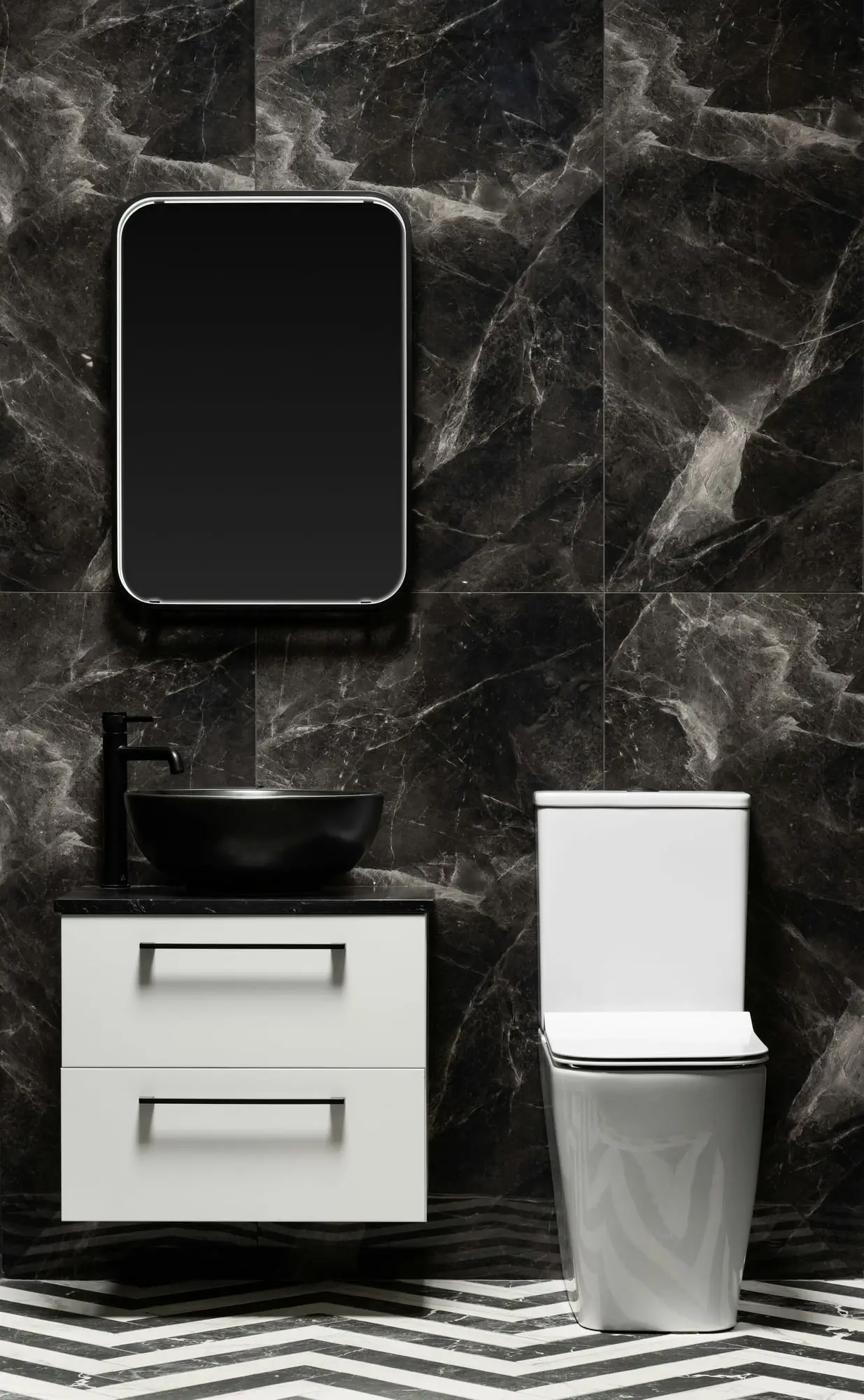 Compact bathroom with dark marble walls, a white floating vanity with a black vessel sink and a white toilet