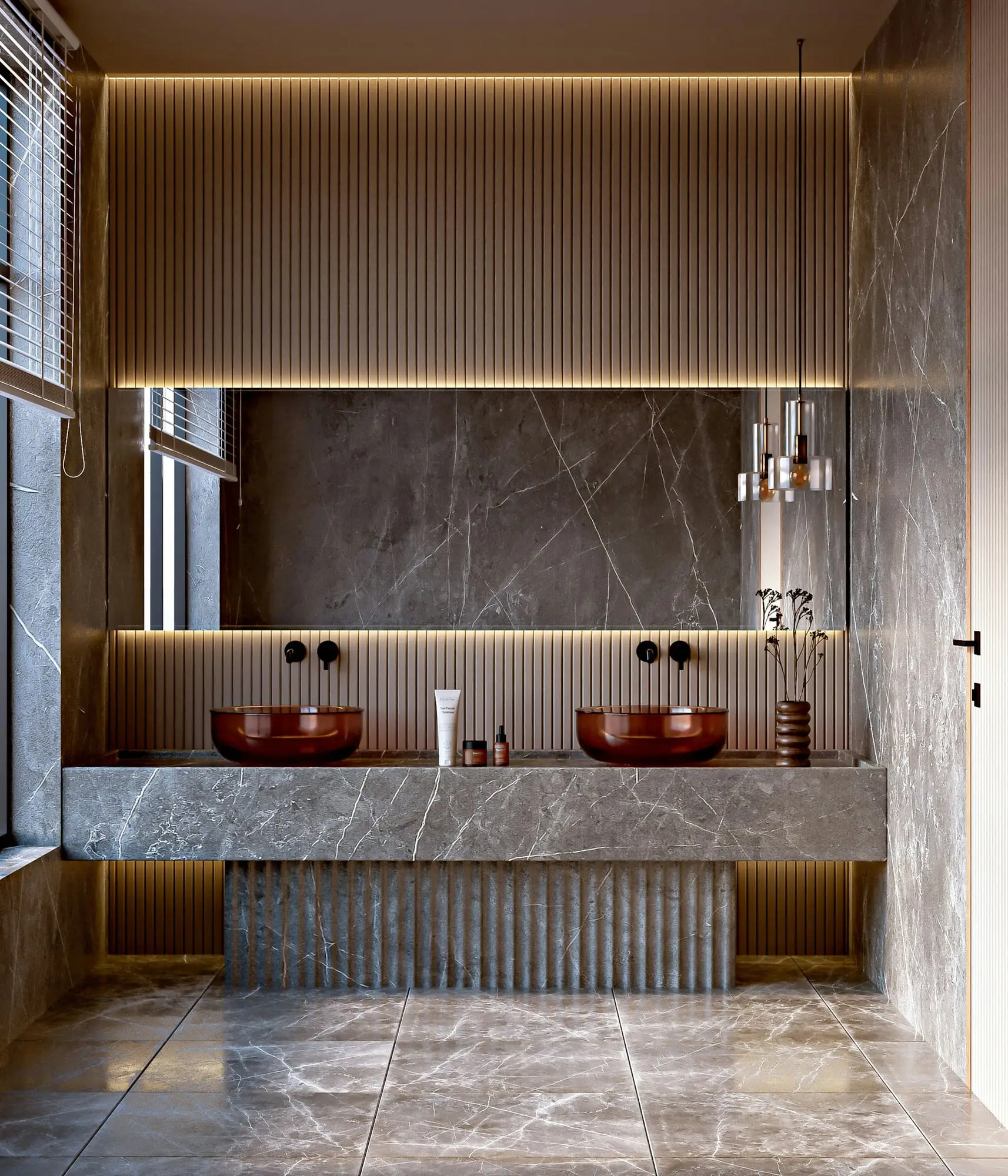Grey stone double vanity with copper vessel sinks, fluted base and a warm backlit wall