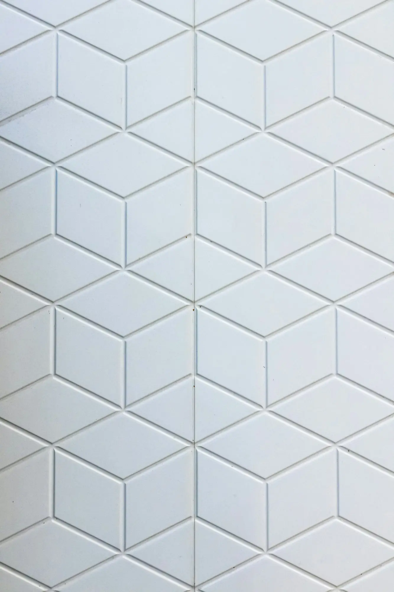 Close-up of white three-dimensional diamond pattern wall tile